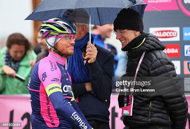 Roberto Ferrari of Italy and Lampre-Merida waits under an umbrella ahead of the second stage of the 2014 Giro d'Italia, a 219km flat road stage on...