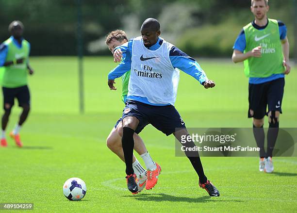 Kim Kallstrom and Abou Diaby of Arsenal during a training session at London Colney on May 10, 2014 in St Albans, England.