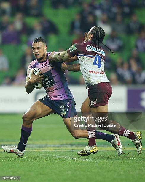 Will Chambers of the Storm pushes off Steve Matai of the Eagles during the round nine NRL match between the Melbourne Storm and the Manly-Warringah...