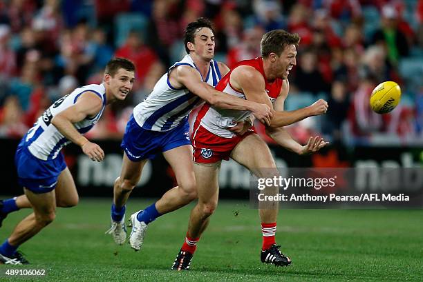 Jeremy Laidler of the Swans tackled by Taylor Garner of the Roos during the First AFL Semi Final match between the Sydney Swans and the North...