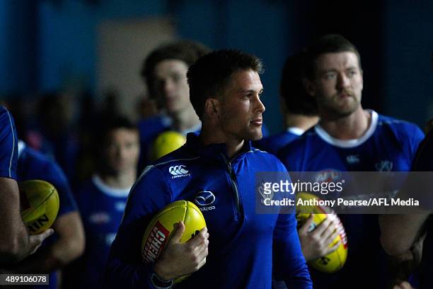 Captain Andrew Swallow of the Roos leads the team out for warm-up during the First AFL Semi Final match between the Sydney Swans and the North...