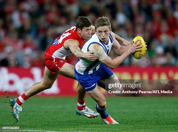 Jake Lloyd of the Swans tackles Jack Ziebell of the Roos during the First AFL Semi Final match between the Sydney Swans and the North Melbourne...