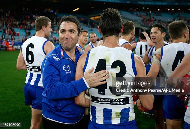 Coach Brad Scott congratulates Sam Gibson of the Roos during the First AFL Semi Final match between the Sydney Swans and the North Melbourne...