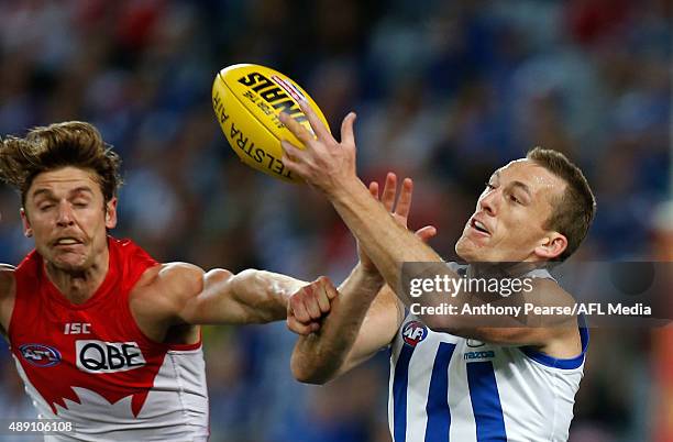 Drew Petrie of the Roos contests the ball with Dane Rampe of the Swans during the First AFL Semi Final match between the Sydney Swans and the North...