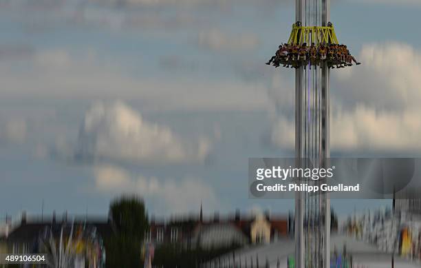 Revellers enjoy their ride in a freefall tower on the opening day of the 2015 Oktoberfest on September 19, 2015 in Munich, Germany. The 182nd...