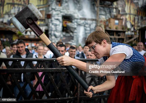 Katha swings the hammer during a game of "Hau den Lukas" on the opening day of the 2015 Oktoberfest on September 19, 2015 in Munich, Germany. The...
