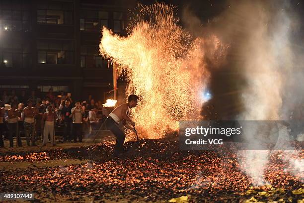 Barefooted man performs Fire Walking around the burning charcoal on September 18, 2015 in Pan'an County, Jinhua City, Zhejiang Province of China. 27...