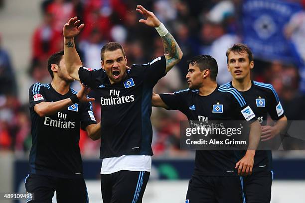 Pierre-Michel Lasogga of Hamburg celebrates his team's first goal with team mates Hakan Calhanoglu, Tomas Rincon and Robert Tesche during the...