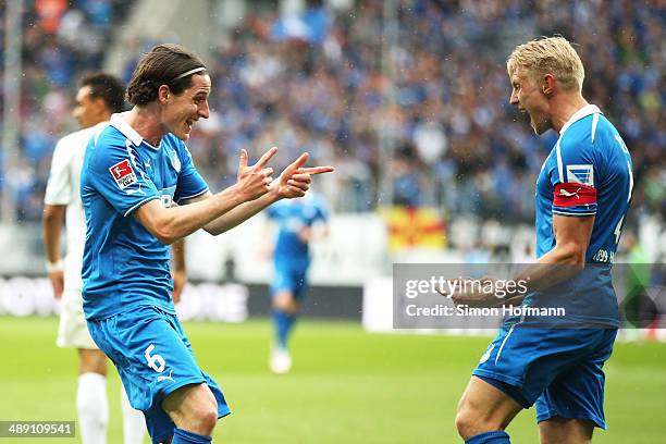 Sebastian Rudy of Hoffenheim celebrates his team's first goal with his team mate Andreas Beck during the Bundesliga match between 1899 Hoffenheim and...