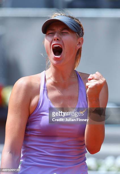Maria Sharapova of Russia celebrates winning a game against Agnieszka Radwanska of Poland during day eight of the Mutua Madrid Open tennis tournament...