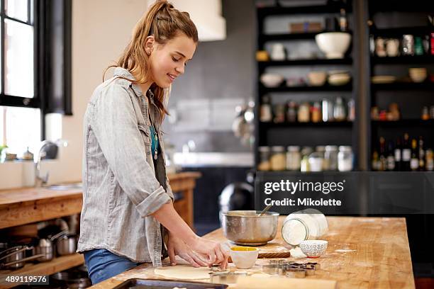 baking makes her happy - teenager cooking stock pictures, royalty-free photos & images