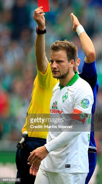 Referee Bastian Dankert shows Philipp Bargfrede of Bremen the red card during the Bundesliga match between Werder Bremen and FC Ingolstadt at...