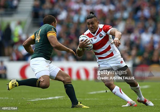 South Africa's wing Bryan Habana runs to Japan's centre Male Sau during a Pool B match of the 2015 Rugby World Cup between South Africa and Japan at...