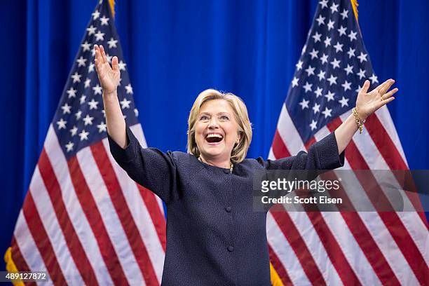 Democratic presidential candidate Hillary Clinton raises her arms stands on stage during the New Hampshire Democratic Party Convention at the Verizon...