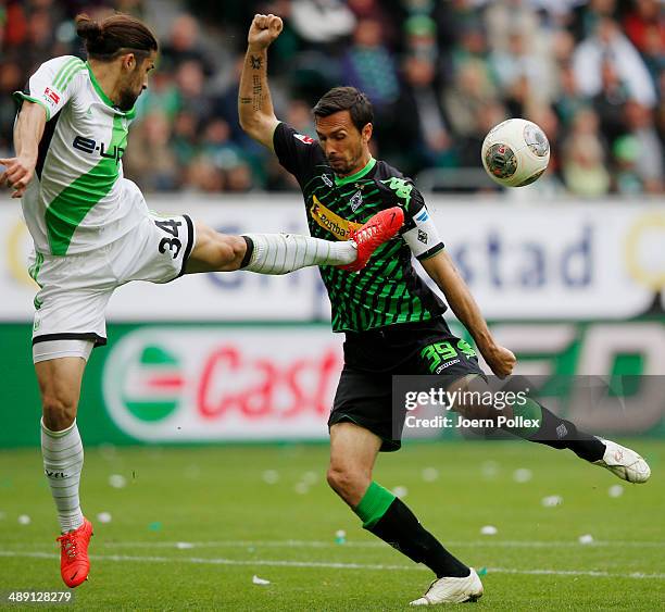 Ricardo Rodriguez of Wolfsburg and Martin Stranzl of Moenchengladbach compete for the ball during the Bundesliga match between at Volkswagen Arena on...