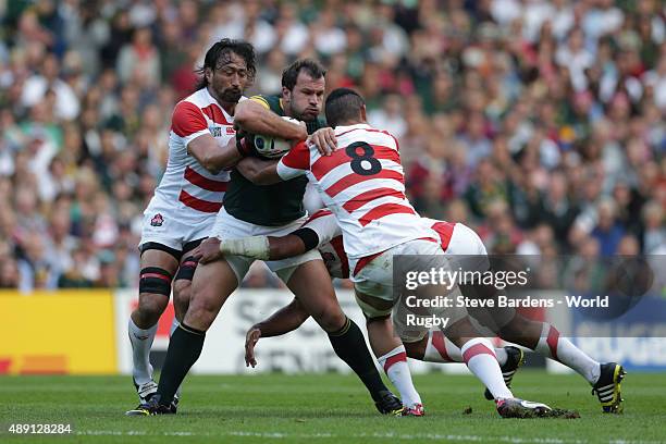 Bismarck Du Plessis of South Africa is tackled by Hendrik Tui of Japan during the 2015 Rugby World Cup Pool B match between South Africa and Japan at...