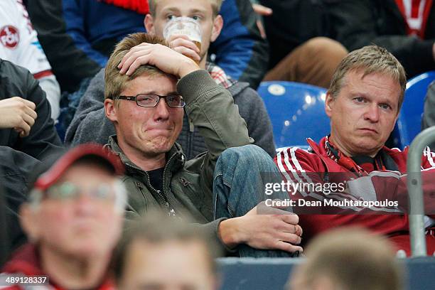 Nuernberg fan looks dejected with confirmed relegation after the Bundesliga match between FC Schalke 04 and 1. FC Nuernberg held at Veltins-Arena on...