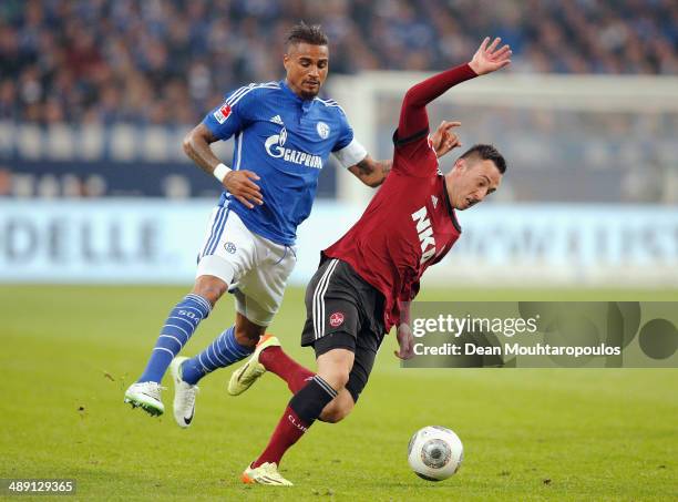 Kevin-Prince Boateng of Schalke and Josip Drmic of Nuernberg battle for the ball during the Bundesliga match between FC Schalke 04 and 1. FC...