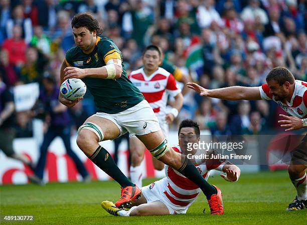 Lodewyk De Jager of South Africa breaks clear of the Japan defence to sacore his team's third try during the 2015 Rugby World Cup Pool B match...