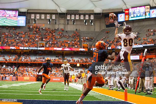 Anthony Rice of the Central Michigan Chippewas jumps and fails to bring in a touchdown pass attempt as Chauncey Scissum of the Syracuse Orange...
