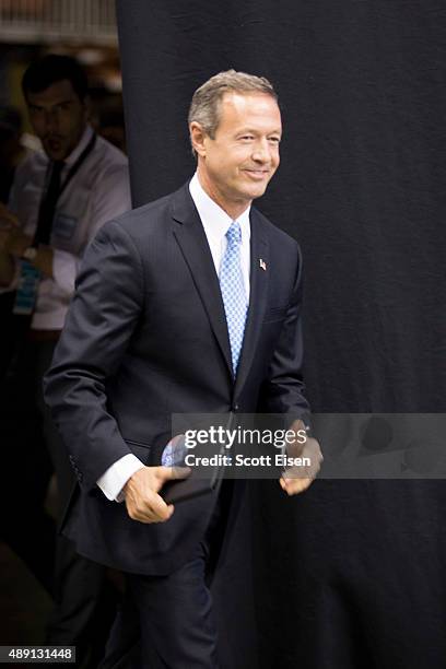 Democratic presidential candidate and former Maryland Governor Martin O'Malley smiles while walking from backstage during the New Hampshire...