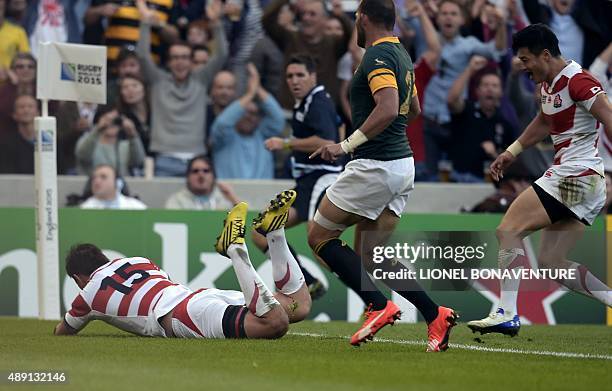 Japan's full-back Ayumu Goromaru scores a try during a Pool B match of the 2015 Rugby World Cup between South Africa and Japan at the Brighton...