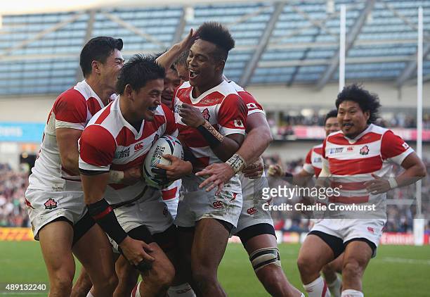 Japan players celebrate the try of Ayumu Goromaru of Japan during the 2015 Rugby World Cup Pool B match between South Africa and Japan at the...