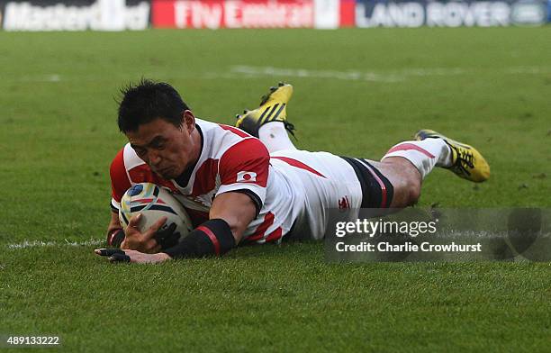 Ayumu Goromaru of Japan dives over to score his team's second try during the 2015 Rugby World Cup Pool B match between South Africa and Japan at the...