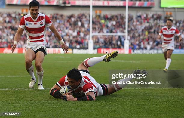 Ayumu Goromaru of Japan dives over to score his team's second try during the 2015 Rugby World Cup Pool B match between South Africa and Japan at the...