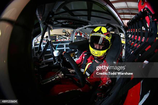 Jamie McMurray, driver of the McDonald's/Cessna Chevrolet, sits in his car during practice for the NASCAR Sprint Cup Series MyAFibRisk.com 400 at...