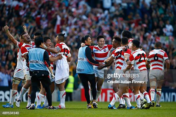 Japan players celebrate their surprise victory during the 2015 Rugby World Cup Pool B match between South Africa and Japan at the Brighton Community...