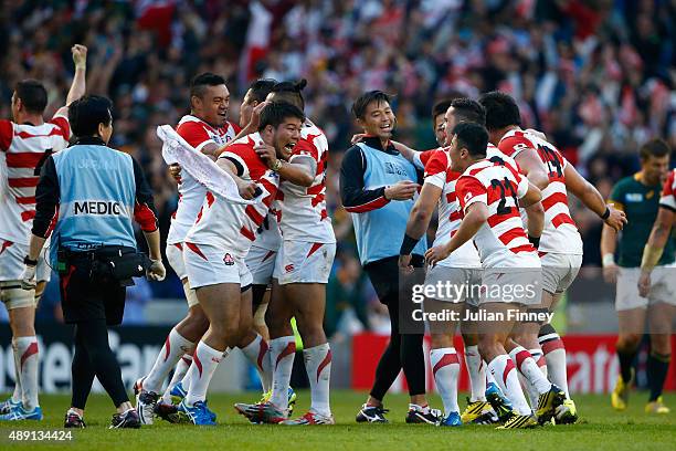 Japan players celebrate their surprise win during the 2015 Rugby World Cup Pool B match between South Africa and Japan at the Brighton Community...