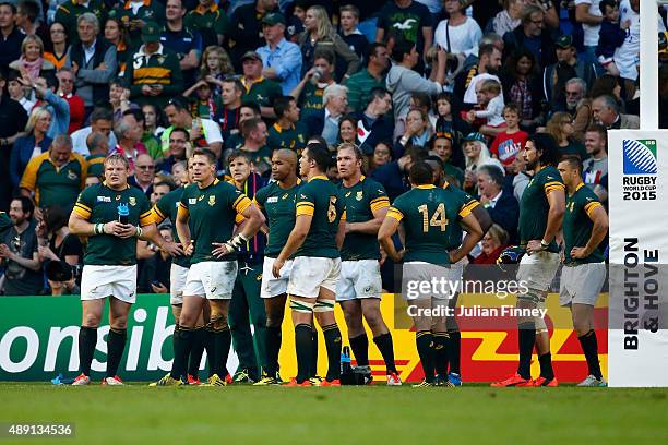 Dejected South Africa players are stunned following their defeat in the 2015 Rugby World Cup Pool B match between South Africa and Japan at the...