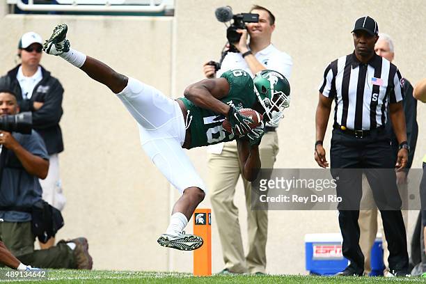 Aaron Burbridge of the Michigan State Spartans makes a catch for a touchdown against the Air Force Falcons at Spartan Stadium on September 19, 2015...