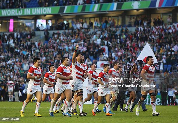 Japan players celebrate their surprise victory in the 2015 Rugby World Cup Pool B match between South Africa and Japan at the Brighton Community...