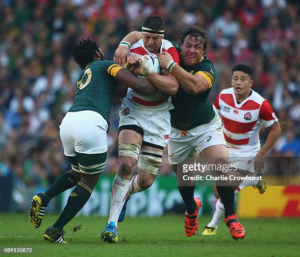 Luke Thompson of Japan drives through the South Africa defence during the 2015 Rugby World Cup Pool B match between South Africa and Japan at the...