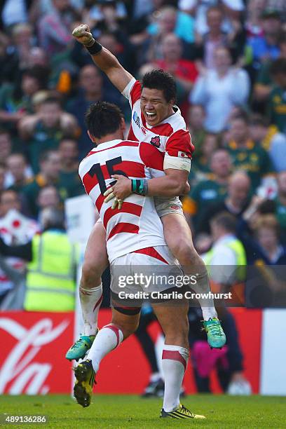 Ayumu Goromaru of Japan celebrates with Harumichi Tatekawa of Japan following victory in the 2015 Rugby World Cup Pool B match between South Africa...