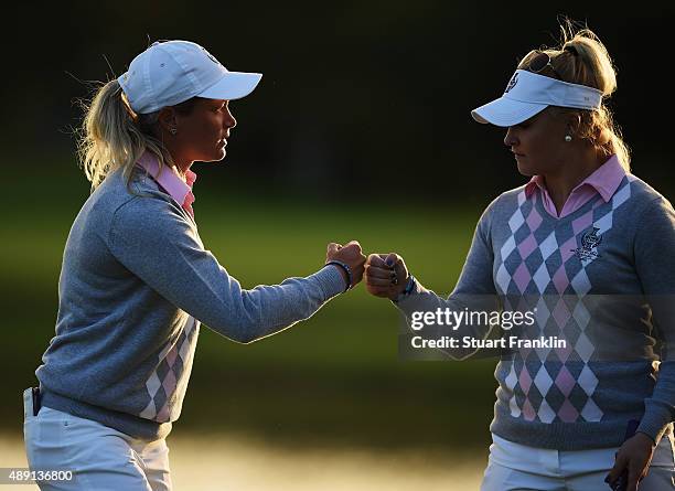 Suzann Pettersen of team Europe high fives with Charley Hull during the afternoon fourball matches at The Solheim Cup at St Leon-Rot Golf Club on...