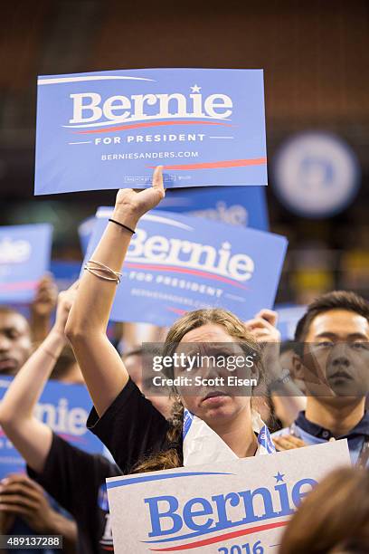 Supporters of democratic presidential candidate Senator Bernie Sanders hold up signs while he talks on stage during the New Hampshire Democratic...