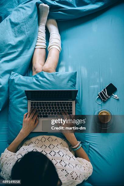 girl in bed with lap top - bed overhead view stock pictures, royalty-free photos & images
