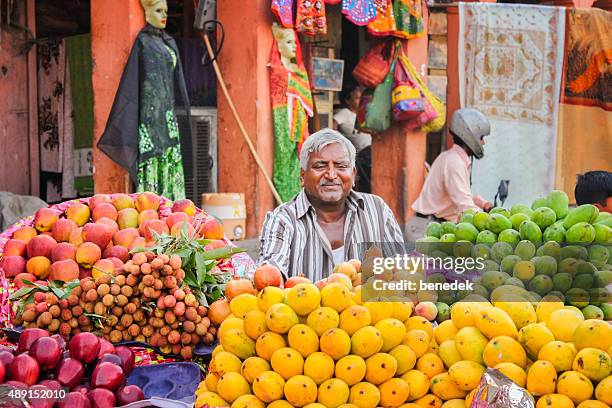 fruit vendor man at market in jaipur india - mangoes stock pictures, royalty-free photos & images