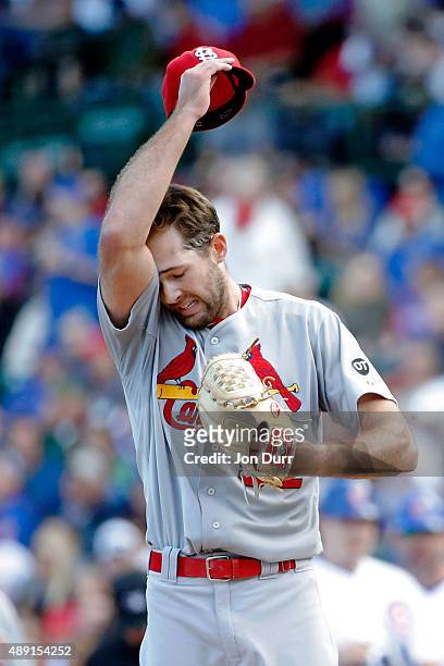Jordan Walden of the St. Louis Cardinals reacts after walking Trevor Cahill of the Chicago Cubs during the fourth inning against the Chicago Cubs at...
