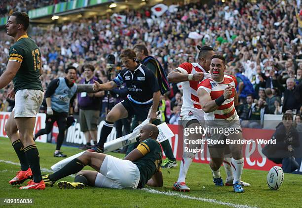 Karne Hesketh of Japan celebrates scoring the winning try during the 2015 Rugby World Cup Pool B match between South Africa and Japan at Brighton...
