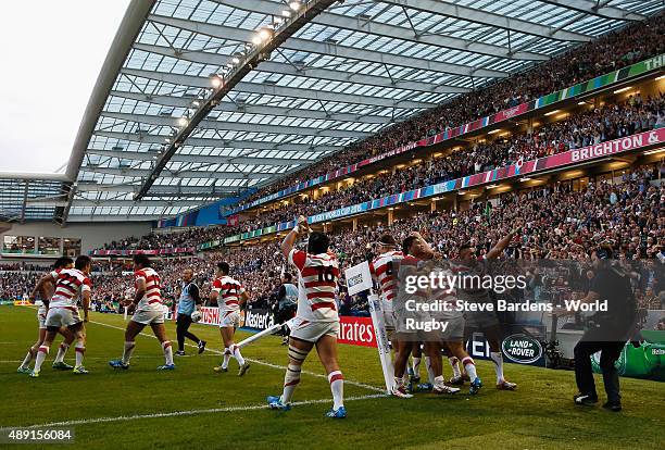 Japan players celebrate the winning try of Karne Hesketh of Japan during the 2015 Rugby World Cup Pool B match between South Africa and Japan at...
