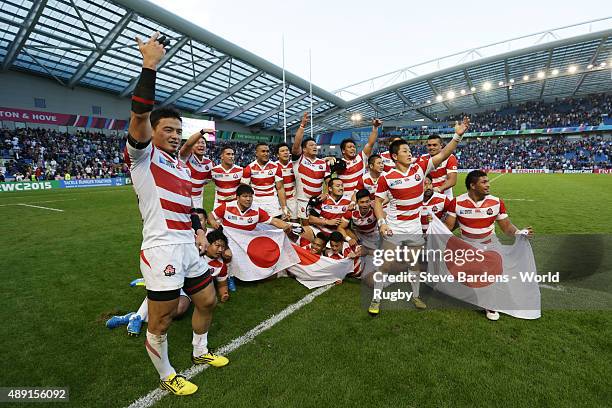 Japan players celebrate their surprise win during the 2015 Rugby World Cup Pool B match between South Africa and Japan at Brighton Community Stadium...
