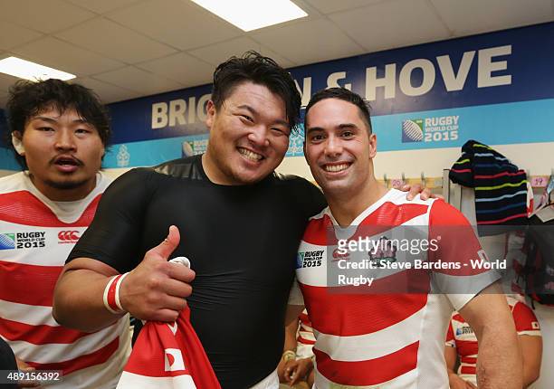 Hiroshi Yamashita and Karne Hesketh of Japan celebrate their victory in the dressing room following the 2015 Rugby World Cup Pool B match between...