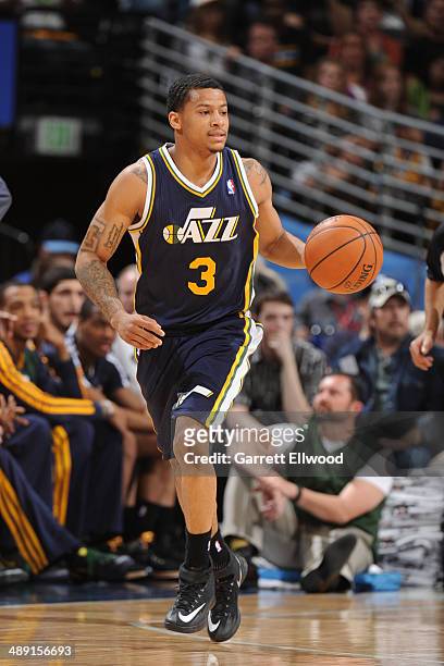 Trey Burke of the Utah Jazz moves the ball up-court against the Denver Nuggets on April 12, 2014 at the Pepsi Center in Denver, Colorado. NOTE TO...