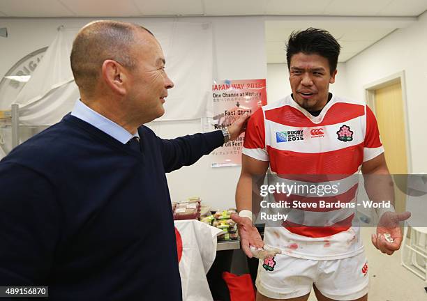 Japan coach Eddie Jones congratulates his player Takeshi Kizu following their surprise victory in the 2015 Rugby World Cup Pool B match between South...