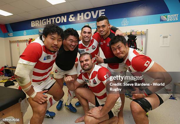 Japan players celebrate in the dressing room following victory in the 2015 Rugby World Cup Pool B match between South Africa and Japan at Brighton...