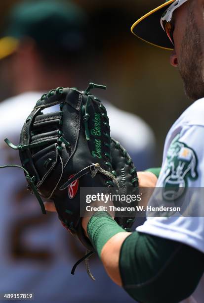 Detailed view of Daric Barton of the Oakland Athletics checking out his Rawlings first baseman's glove during game one of a doubleheader against the...